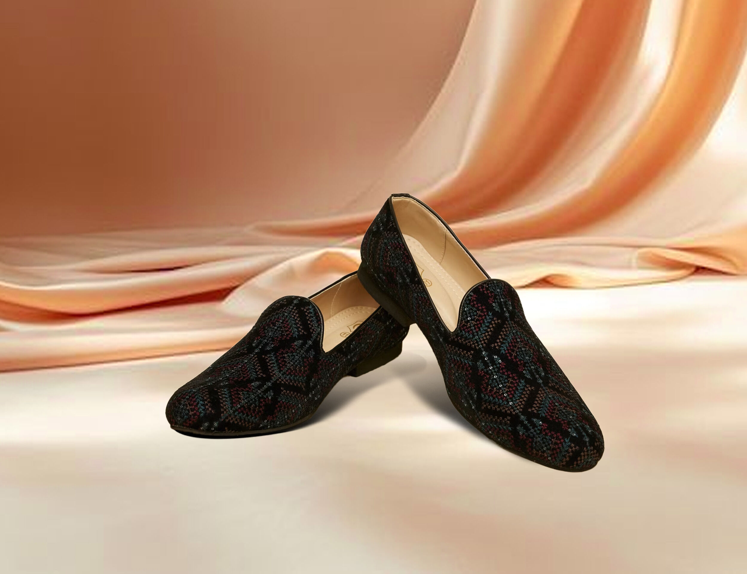 Elegant black jutti featuring a vibrant colorful pattern, blending tradition with modern style.